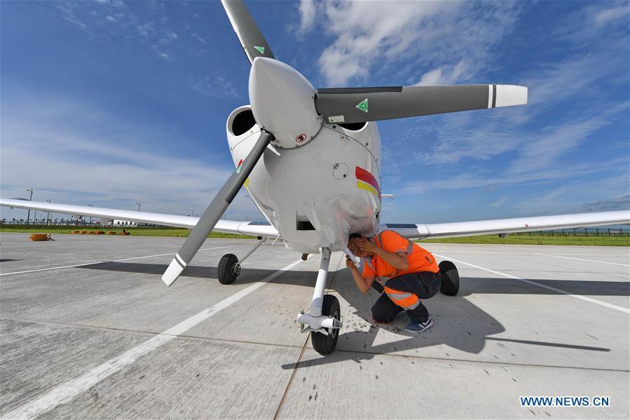 <?php echo strip_tags(addslashes(Deng Yun checks an aircraft at the Chagan Lake airport in Songyuan, northeast China's Jilin Province, July 17, 2018. Deng was born in 1991. She is an aircraft maintenance technician of an aviation academy in Jilin. The young female engineer and other nine colleagues are in charge of training plane maintenance at the airport. To ensure the flight safety, they need to check more than 100 items before a plane takes off. (Xinhua/Zhang Nan))) ?>