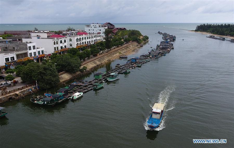 A fishing boat sails back to a harbor in Qionghai, south China\'s Hainan Province, July 17, 2018. Ferry services on the Qiongzhou Strait in south China have been halted as of Tuesday afternoon as a typhoon is fast approaching the southern provinces of Hainan and Guangdong, local authorities have said. Son-Tinh, the ninth typhoon this year, is expected to make landfall in Hainan and Guangdong on Wednesday morning, according to China\'s National Meteorological Center. (Xinhua/Yang Guanyu)