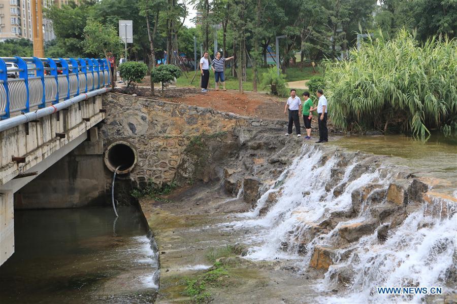 River chiefs check a sewage pipeline along the Jushan River in Xingyi City of southwest China\'s Guizhou Province, July 15, 2018. China has rolled out its river chief scheme nationwide ahead of schedule amid efforts to combat water pollution, a senior official said Tuesday. As of the end of June, more than 1.06 million river chiefs have been appointed at various levels nationwide, and six mechanisms have been set up to facilitate their work, Minister of Water Resources E Jingping told a press conference. (Xinhua/Ou Dongqu)