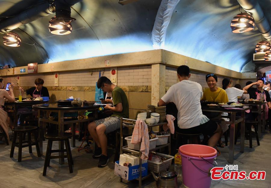 <?php echo strip_tags(addslashes(A popular hot pot restaurant inside a former air-raid shelter in Southwest China’s Chongqing Municipality, July 17, 2018. Authorities in Chongqing have allowed for the development of air-raid shelters, and they have been converted into wine cellars, restaurants and gas stations. The venues become especially popular in summer as it’s usually cool inside. (Photo: China News Service/Zhou Yi))) ?>