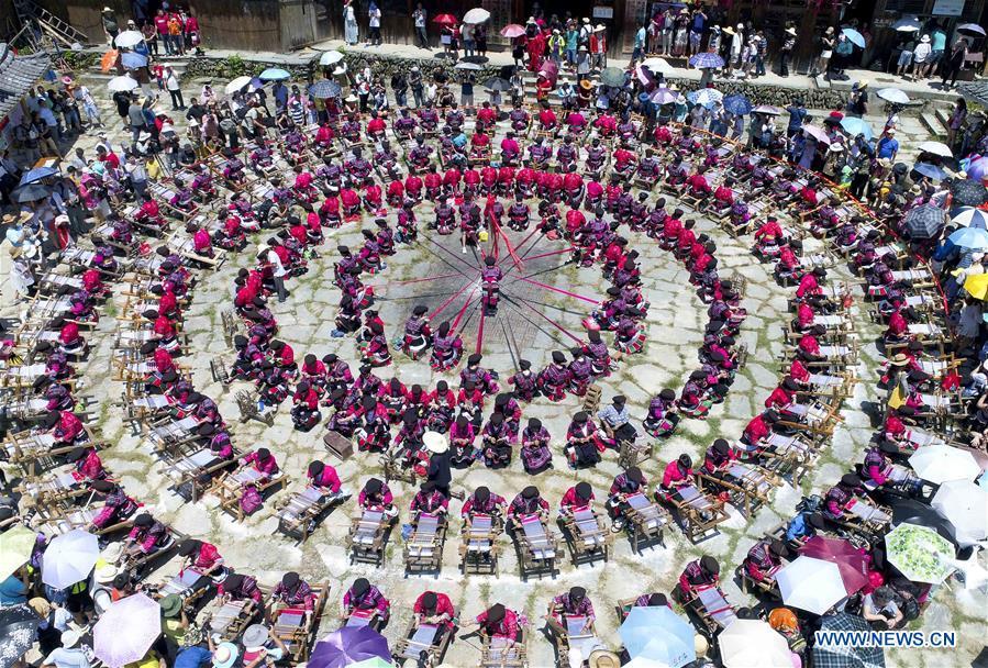 Aerial photo taken on July 18, 2018 shows women of Yao ethnic group presenting the skills of making folk costumes in Longji Township of Guilin, south China\'s Guangxi Zhuang Autonomous Region. Local people of Yao ethnic group on Wednesday celebrated annual \