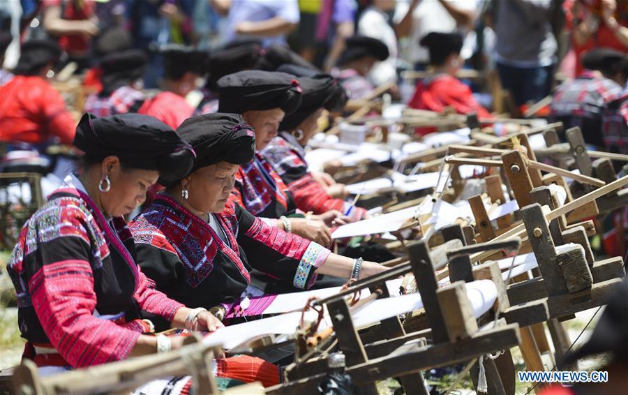 Women of Yao ethnic group present the skills of making folk costumes in Longji Township of Guilin, south China\'s Guangxi Zhuang Autonomous Region, July 18, 2018. Local people of Yao ethnic group on Wednesday celebrated annual \