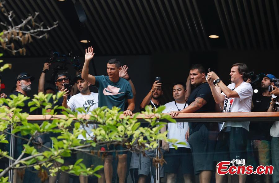 Portuguese professional footballer Cristiano Ronaldo waves to fans during a commercial activity in Beijing, July 19, 2018. (Photo: China News Service/Jia Tianyong)