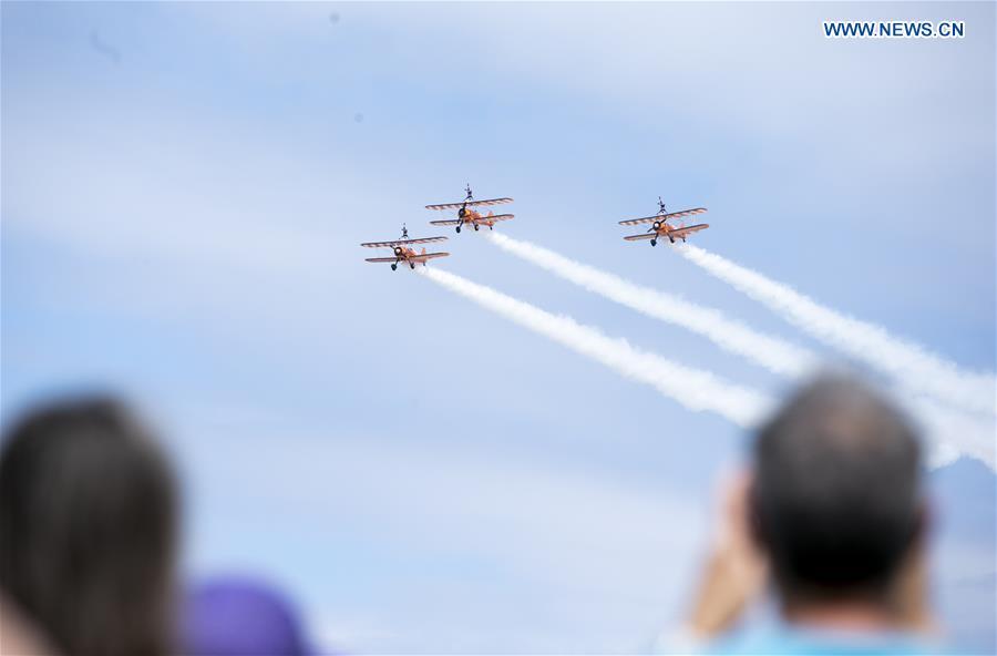 People watch the flying display at the Farnborough International Airshow, south west of London, Britain on July 22, 2018. (Xinhua/Han Yan)