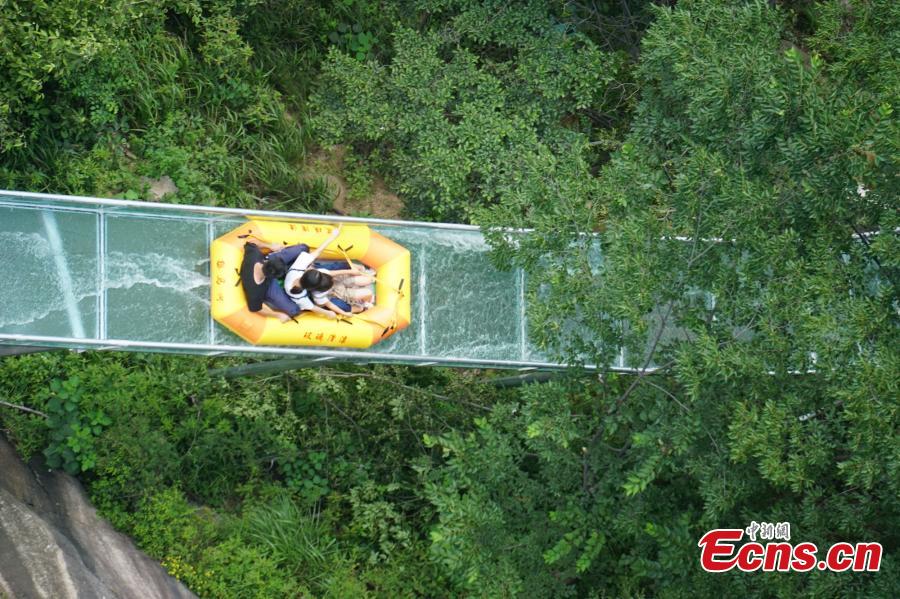 <?php echo strip_tags(addslashes(An aerial view of a waterslide over the Xiangma River in Lushan County, Central China’s Henan Province, July 23, 2018. The 2.3-kilometer-long waterslide around a mountain slope and cliff has a vertical drop of 100 meters, earning it the title of the longest and most challenging waterslide in central China. The thrilling project opened on Monday. (Photo: China News Service/Dong Fei))) ?>
