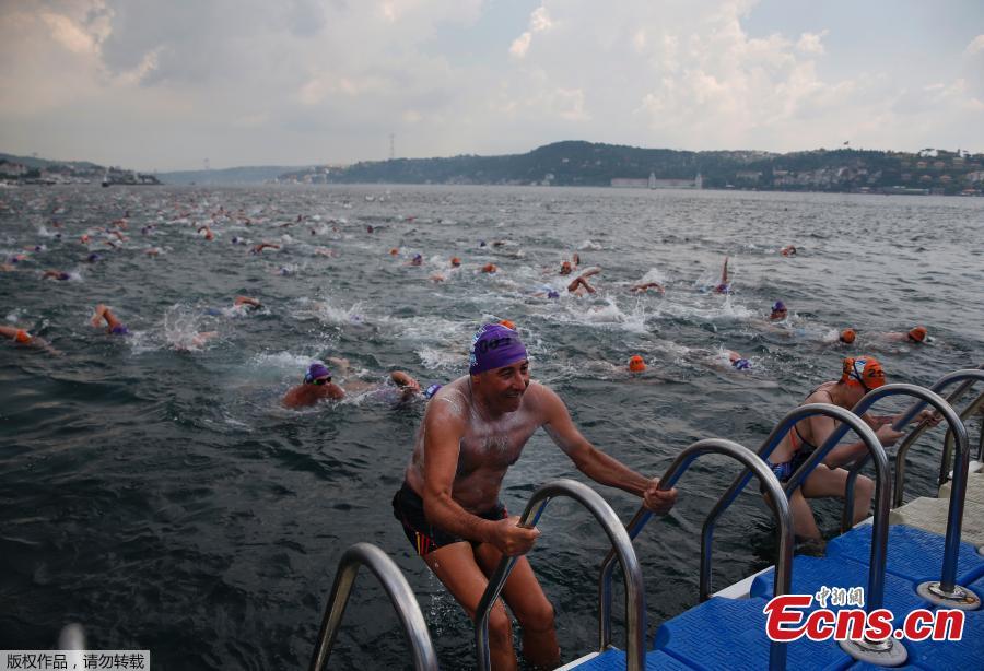 <?php echo strip_tags(addslashes(An athlete gets out of the water after he swam from Asia to Europe in the Bosphorus strait during the Bosporus Cross-Continental Swimming Race in Istanbul, July 22, 2018. Over 2,000 open-water competitors plunged into the water from a ferry docked on the city's Asian side and swam for about 6.5km in the cross-continental event. (Photo/Agencies))) ?>