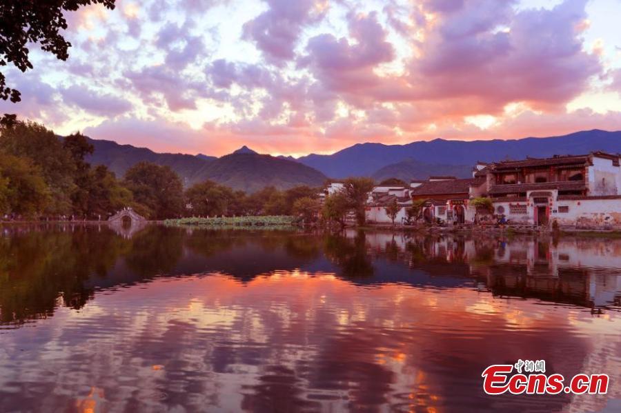 <?php echo strip_tags(addslashes(A spectacular view of Nanhu Lake in Hongcun Village at sunset in Huangshan City, Anhui Province. The two traditional villages of Xidi and Hongcun were inscribed as UNESCO World Heritage sites in 2000 as their unique landscapes, architectural forms, decorative features, and construction techniques all retain the original features of Anhui villages from the 14th to 20th centuries. (Photo: China News Service/Shi Guangde))) ?>