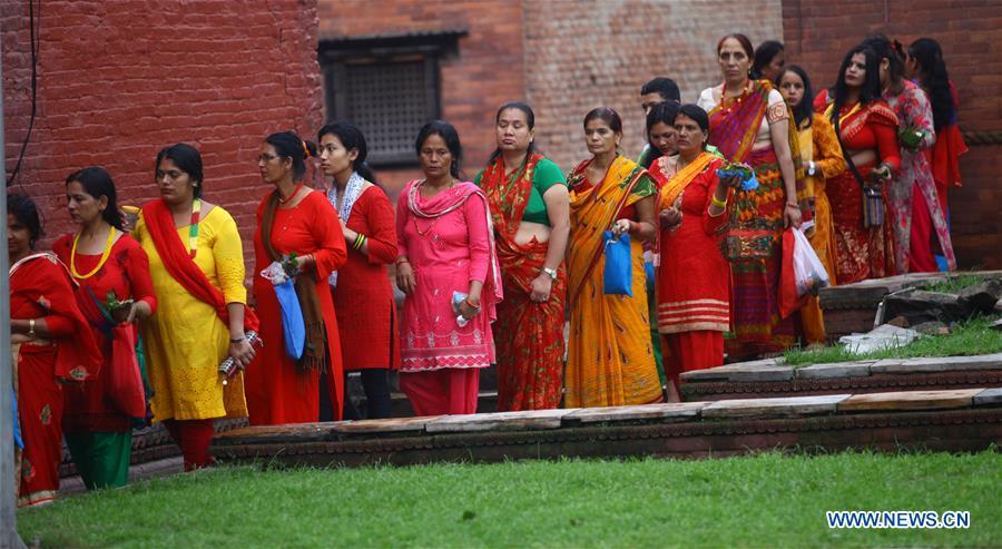Hindu women queue to offer prayers on Shrawan Somvar at Pashupatinath Temple in Kathmandu, Nepal, July 23, 2018. Mondays in the holy month of Shrawan are considered auspicious for Hindu women as they fast and offer prayers to Lord Shiva for the long and prosperous life for their husbands. (Xinhua/Sunil Sharma)