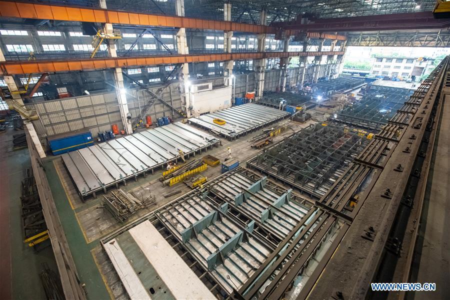 <?php echo strip_tags(addslashes(Staff members work at Hudong-Zhonghua Shipbuilding (Group) Co., Ltd. in east China's Shanghai, July 5, 2018. This year marks the 40th anniversary of China's reform and opening-up policy. (Xinhua/Shen Bohan))) ?>