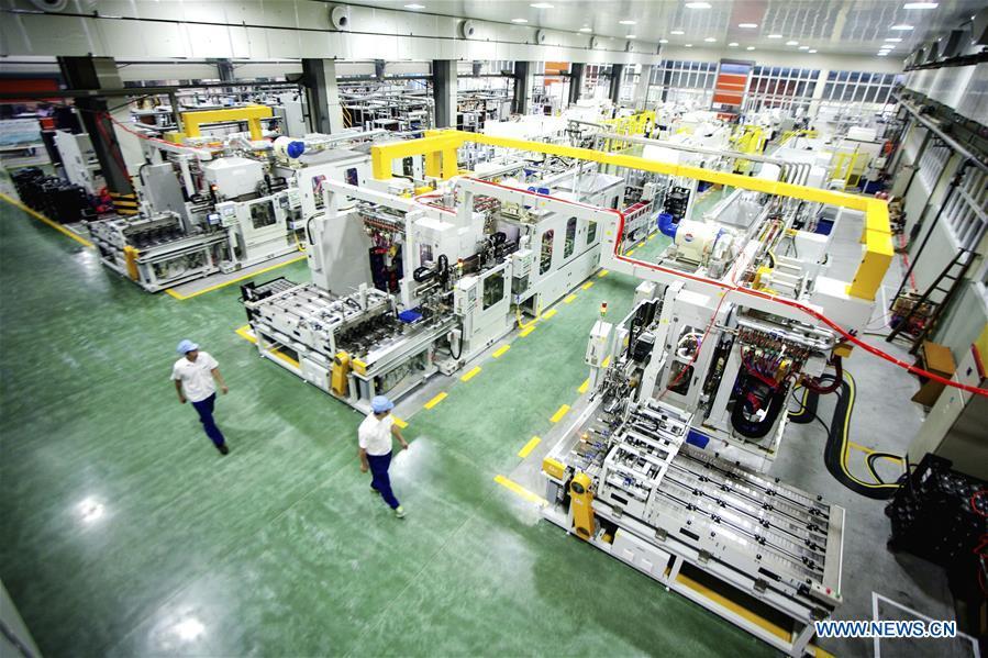 Staff members work at an intelligent plant of Wanxiang Qianchao Co., Ltd. in east China\'s Zhejiang Province, Aug. 13, 2015. This year marks the 40th anniversary of China\'s reform and opening-up policy. (Xinhua)
