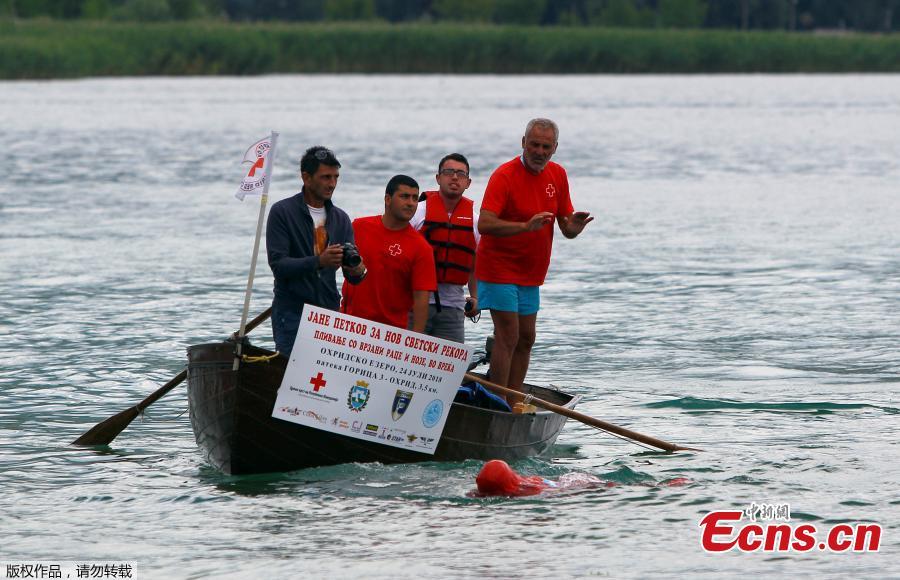 Bulgarian Jane Petkov, 64, wants to set a new Guinness World Record by attempting to swim more than three kilometers at Macedonia\'s Lake Ohrid in a bag with his arms and legs tied up, in Ohrid, Macedonia, July 24, 2018. (Photo/Agencies)