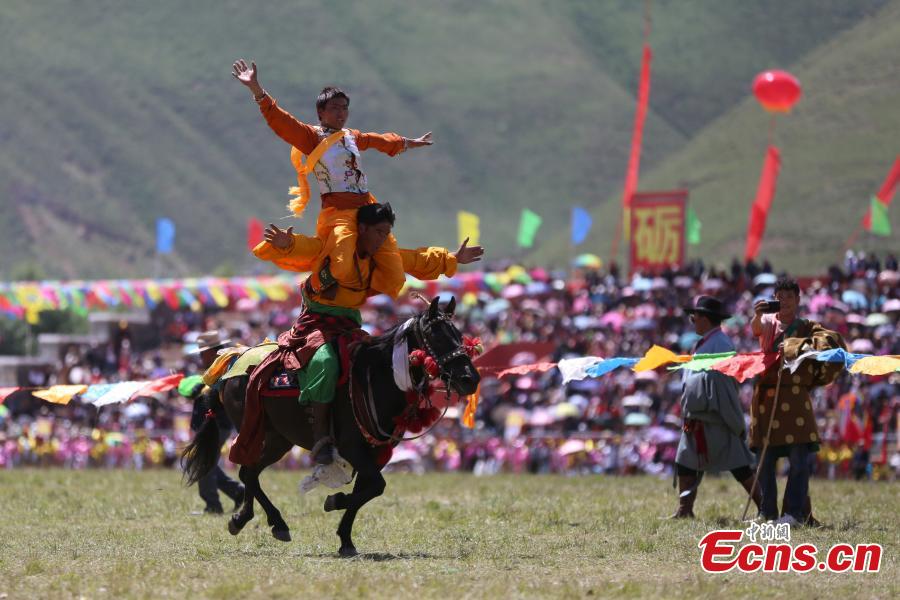 An annual horse racing festival starts in Yushu, Northwest China’s Qinghai Province, July 25, 2018 with stunts performed in the opening ceremony. (Photo: China News Service/Luo Yunpeng)