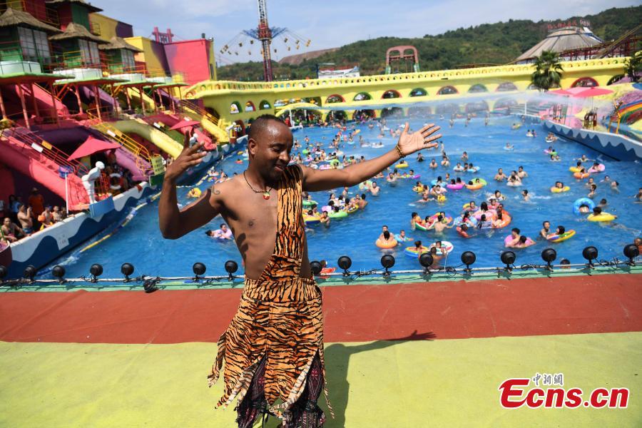 <?php echo strip_tags(addslashes(Sami of Ethiopia performs in the Foreigners Street theme park in Southwest China’s Chongqing Municipality, July 26, 2018. Sami, 28, has worked in Chongqing for nearly 11 years, mainly as a performer to entertain tourists. Sami said he struggled to cope with the sweltering hot days in Chongqing this summer and his employer has allowed him a 25-day off for the high temperatures. (Photo: China News Service/Chen Chao))) ?>