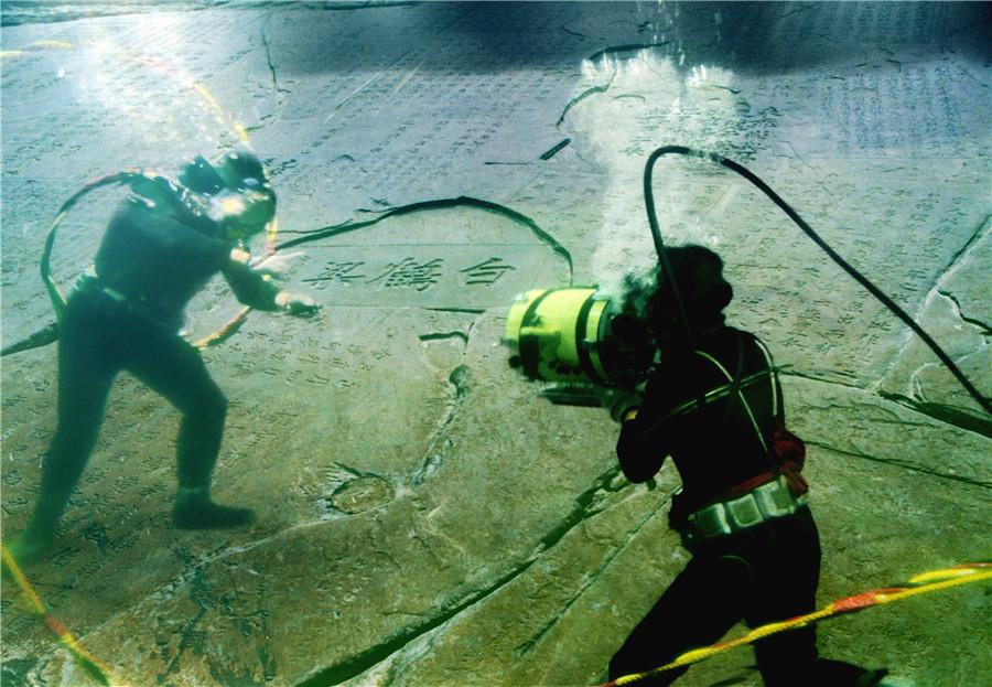 Divers undertake scientific protection work underwater.