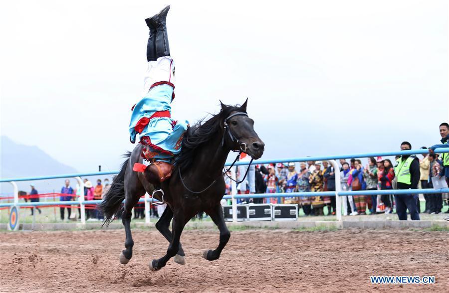 <?php echo strip_tags(addslashes(A horseman performs equestrianism during a traditional ethnic minorities sports meeting held at a racecourse in Sunan Yugur Autonomous County, northwest China's Gansu Province, July 28, 2018. (Xinhua/Wang Jiang))) ?>