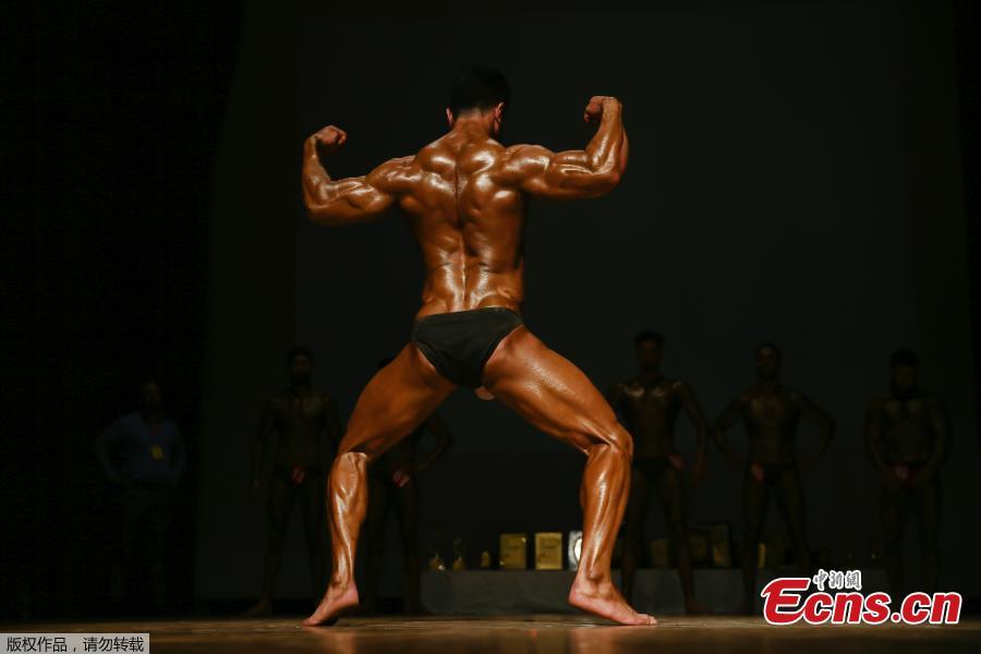 A Kashmiri bodybuilder displays his muscles at a bodybuilding competition in Srinagar, Indian controlled Kashmir, July 28, 2018. Dozens participated in the competition to choose Mr. Kashmir on Saturday. (Photo/Agencies)