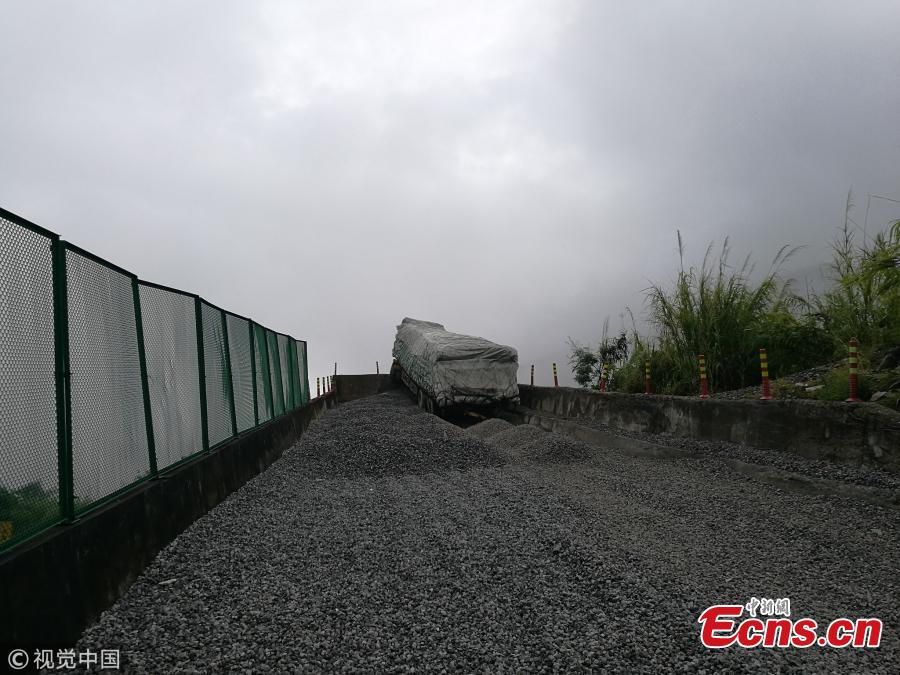 A cargo truck’s cabin hangs on a slip road in Yuxi City, Southwest China’s Yunnan Province, July 26, 2018. Having lost control of the truck on a 27-kilometer-long downward slope, known as the \