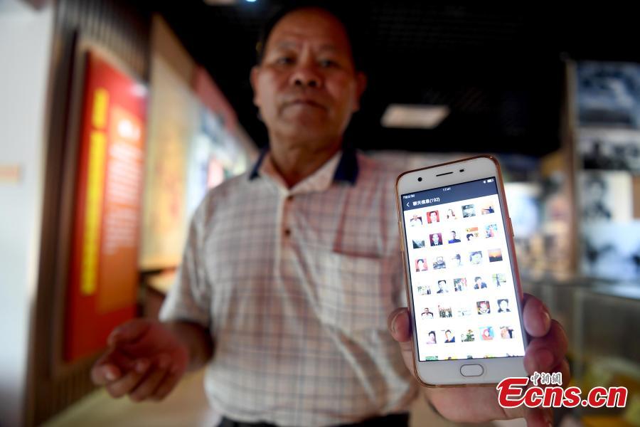Niu Bentong shows a WeChat group for war veterans or the relatives of martyrs in Longzhou County, South China’s Guangxi Zhuang Autonomous Region, July 30, 2018. Niu participated in the China-Vietnam war and witnessed the death of many of his comrades-in-arms in front of him. In 1980, Niu chose to work in the cemetery, where 1,902 martyrs lie, and he continued to work there for 37 years until his retirement this year. He has helped correct information related to more than 400 martyrs and has also shared details online. In his spare time, Niu continues to help at the cemetery, saying it’s hard to forget the days of life and death spent alongside his fellow soldiers. (Photo: China News Service/Yu Jing)