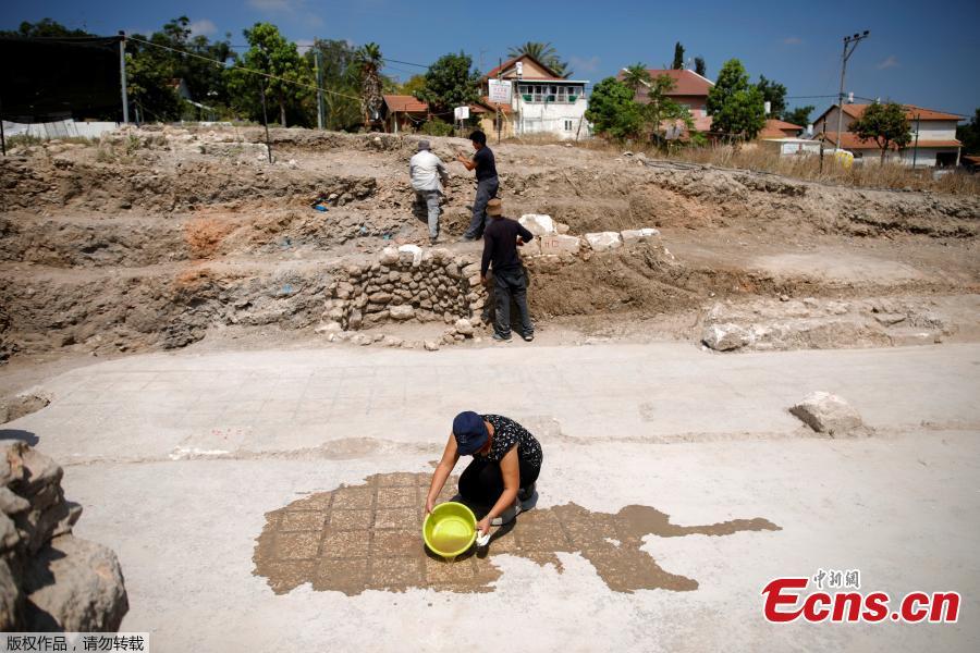 A worker washes a mosaic floor at the site where a large-scale wine jug factory that dates back to the 3rd century and included recreational facilities has been uncovered  in Gedera, according to archeologists, Israel July 31, 2018. (Photo/Agencies)