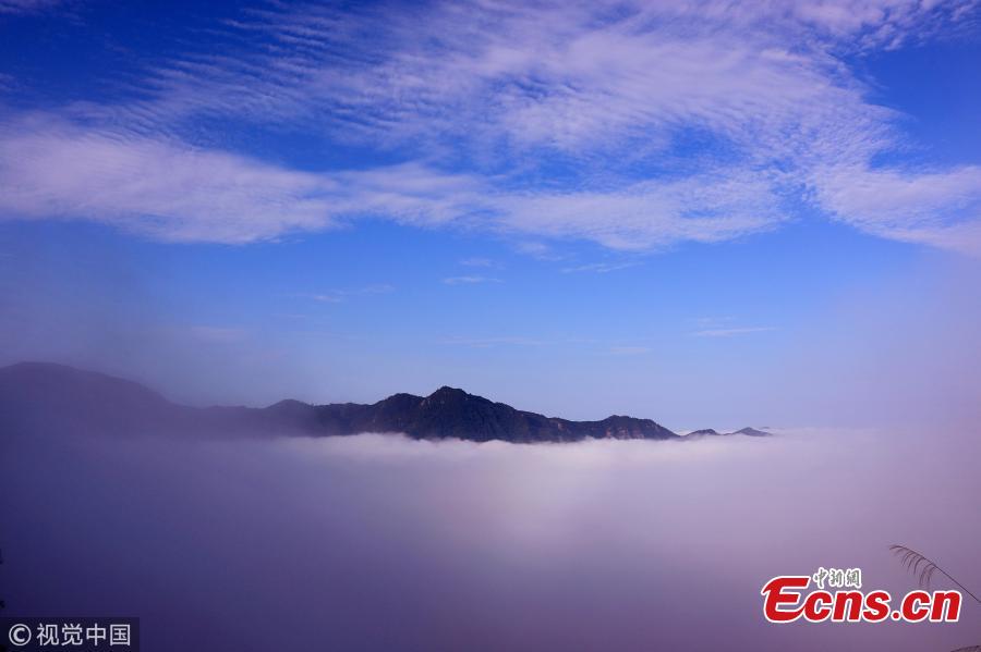 A sea of clouds surrounds Jinlongshan ancient village in Xiuning County, Huangshan City, East China’s Anhui Province, after rain on July 31, 2018. (Photo/VCG)