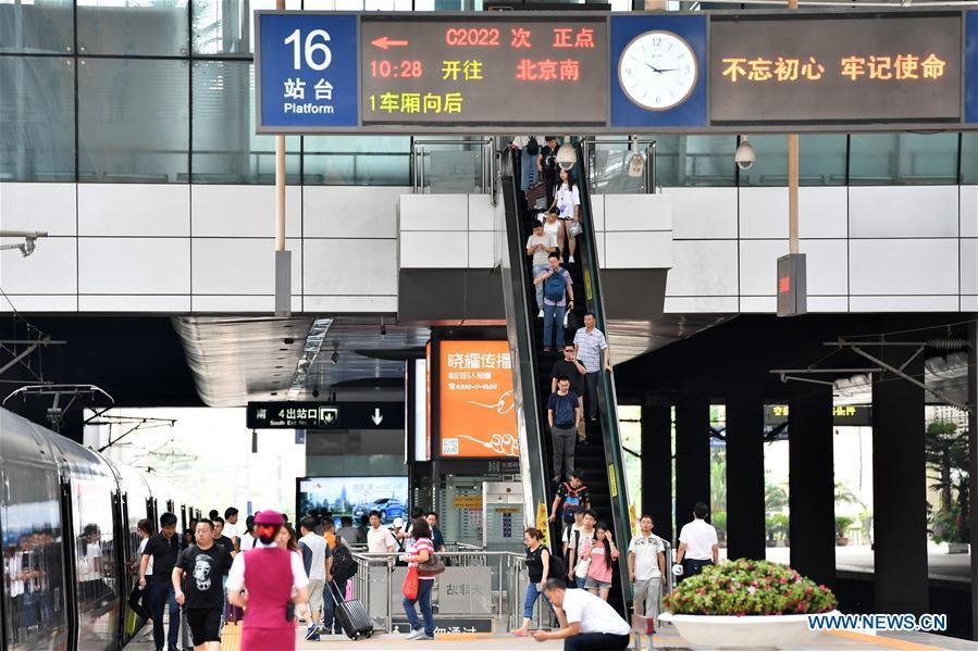 Passengers arrive to board a Beijing-Tianjin intercity train at Tianjin Railway Station in Tianjin, north China, July 10, 2018. On Aug. 1, 2008, the Beijing-Tianjin high-speed train service opened China\'s first high-speed railway line. The length of high-speed railway lines in China increased from zero 10 years ago to 25,000 km by 2017, accounting for 66 percent of the world\'s total. (Xinhua/Li Ran)