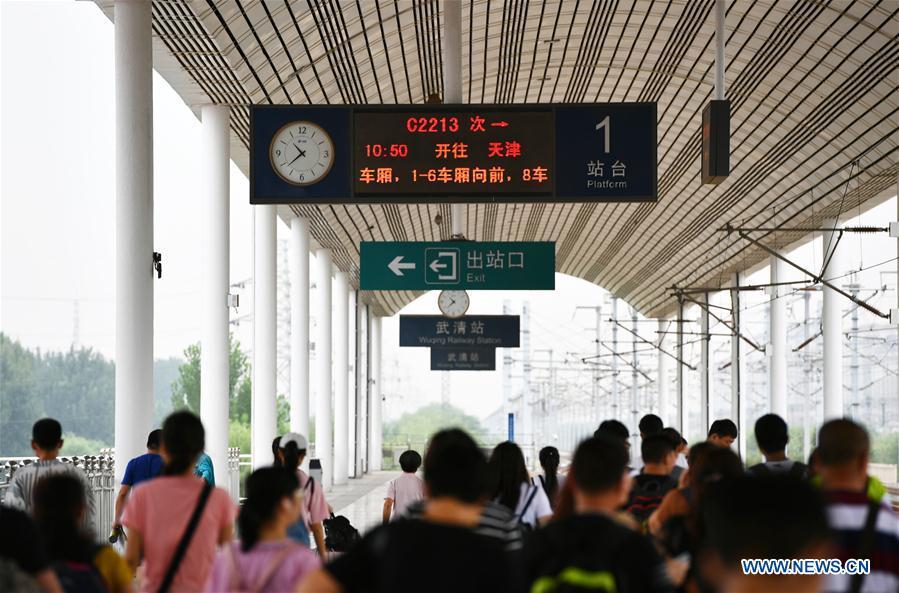 Passengers wait in lines for the train at Wuqing Railway Station in Tianjin, north China, July 11, 2018. On Aug. 1, 2008, the Beijing-Tianjin high-speed train service opened China\'s first high-speed railway line. The length of high-speed railway lines in China increased from zero 10 years ago to 25,000 km by 2017, accounting for 66 percent of the world\'s total. (Xinhua/Li Ran)