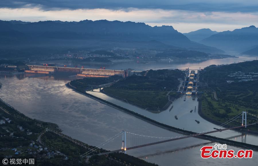 Ships pass the Three Gorges Dam’s five-stage ship lock in Yichang, Central China’s Hubei Province, Aug. 1, 2018. Authorities made use of a break in continuous rain to ease shipping pressure between the Three Gorges Dam and the Gezhouba Dam, both large-scale water control projects on the Yangtze River. Previously, hundreds of ships were suspended to be both upstream and downstream of the Three Gorges Dam due to the massive amounts of floodwater - 35,000 cubic meters per second - being discharged from the dam, which affects navigation safety. (Photo/VCG)