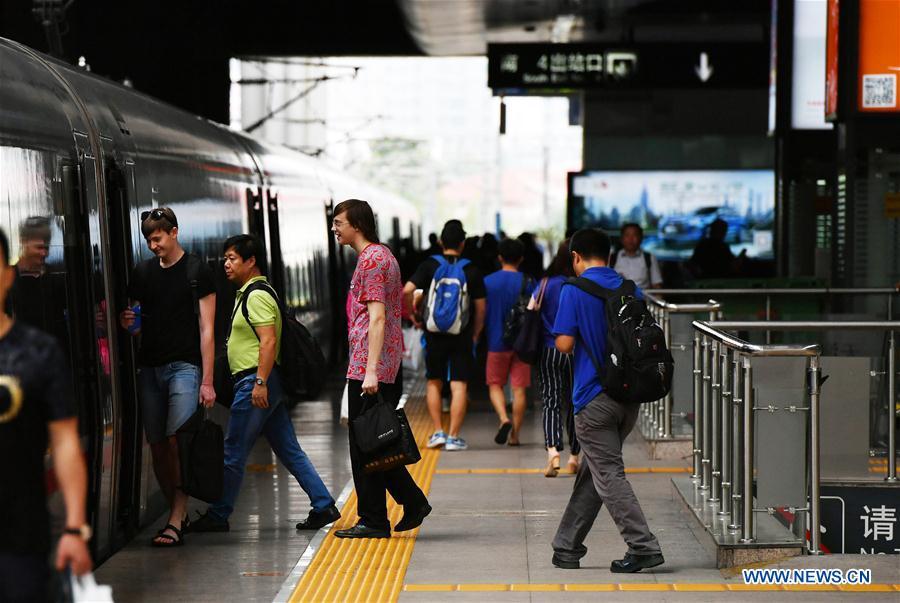 Passengers board a Beijing-Tianjin intercity train at Tianjin Railway Station in Tianjin, north China, July 10, 2018. On Aug. 1, 2008, the Beijing-Tianjin high-speed train service opened China\'s first high-speed railway line. The length of high-speed railway lines in China increased from zero 10 years ago to 25,000 km by 2017, accounting for 66 percent of the world\'s total. (Xinhua/Li Ran)
