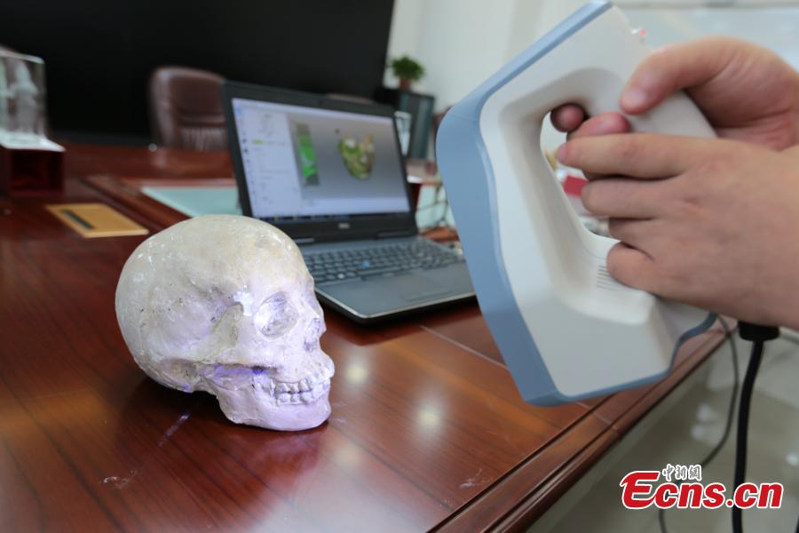 <?php echo strip_tags(addslashes(A student scans a skull for research in Northwest University in Xi’an City, Shaanxi Province, Aug. 2, 2018. Through 