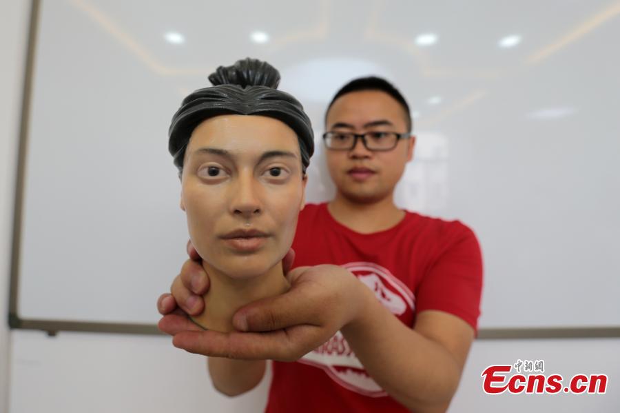 <?php echo strip_tags(addslashes(A student shows a head sculpture of a woman from the Qin Dynasty (221 to 206 BC) made using 3D-printing technology in Northwest University in Xi’an City, Shaanxi Province, Aug. 2, 2018. Through 