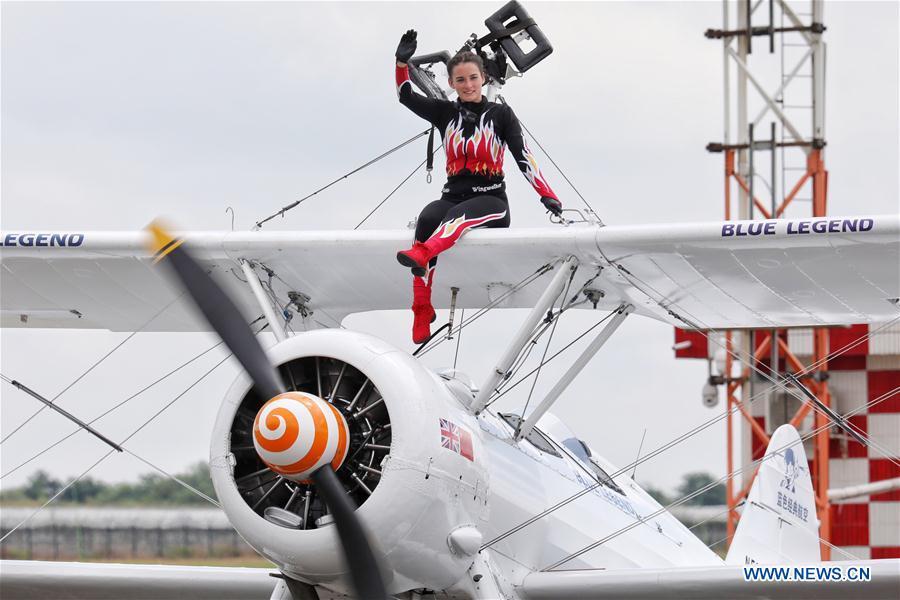 <?php echo strip_tags(addslashes(Performer of an aerobatic team waves after performance during Huangguoshu Waterfalls Flight Conference in Anshun, southwest China's Guizhou Province, Aug. 3, 2018. (Xinhua/Liu Xu))) ?>