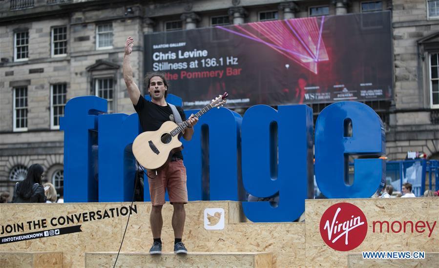 An Australian plays guitar on the opening day of the Edinburgh Festival Fringe 2018 in Edinburgh, Scotland, Britain on Aug. 3, 2018. (Xinhua/Han Yan)