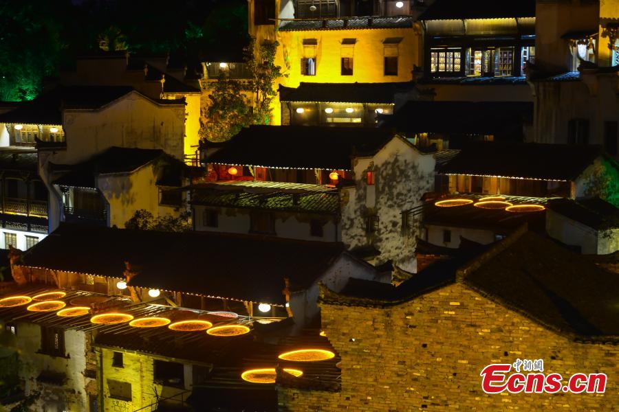Nearly 1,000 visitors enjoy a long banquet along a street in the ancient Huangling village in Wuyuan, East China’s Jiangxi Province, Aug. 4, 2018. The connected tables stretched for hundreds of meters, and local dishes were served up for tourists. (Photo: China News Service/Fang Huabinb)