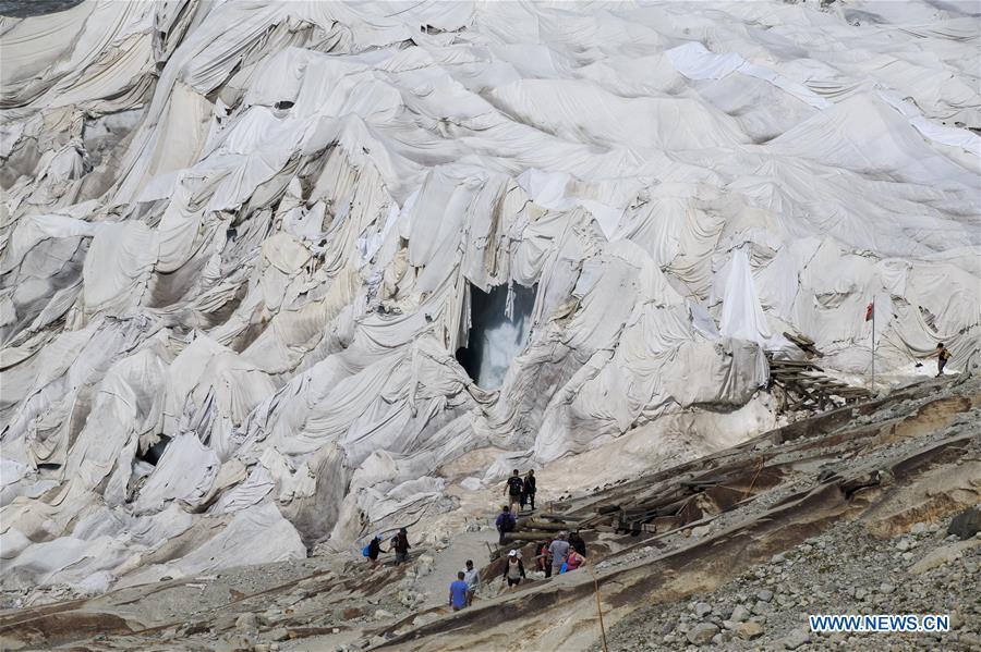 <?php echo strip_tags(addslashes(Photo taken on Aug. 5, 2018 shows the Rhone Glacier covered with white blankets near the Furka Pass in Switzerland. The Rhone Glacier is protected by special white blankets to prevent it from further melting as a result of global warming. (Xinhua/Xu Jinquan))) ?>