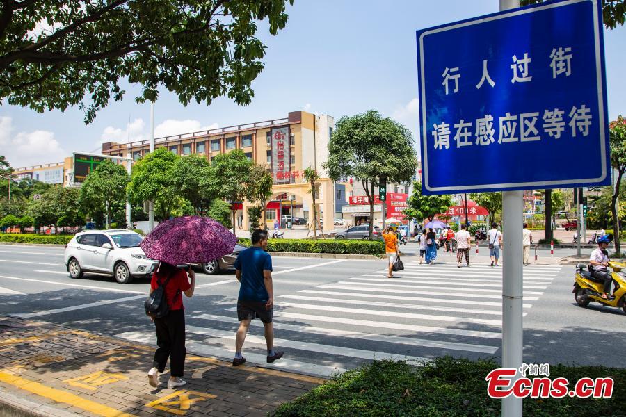 <?php echo strip_tags(addslashes(A smart zebra crossing is put into use in Nanning City, South China’s Guangxi Zhuang Autonomous Region, Aug. 8, 2018. When at least three pedestrians wait near the first smart zebra cross in Guangxi, the duration of green light signal for vehicles will automatically reduces from 120 seconds to 65 seconds, giving priority to pedestrians. (Photo: China News Service/Chen Guanyan))) ?>