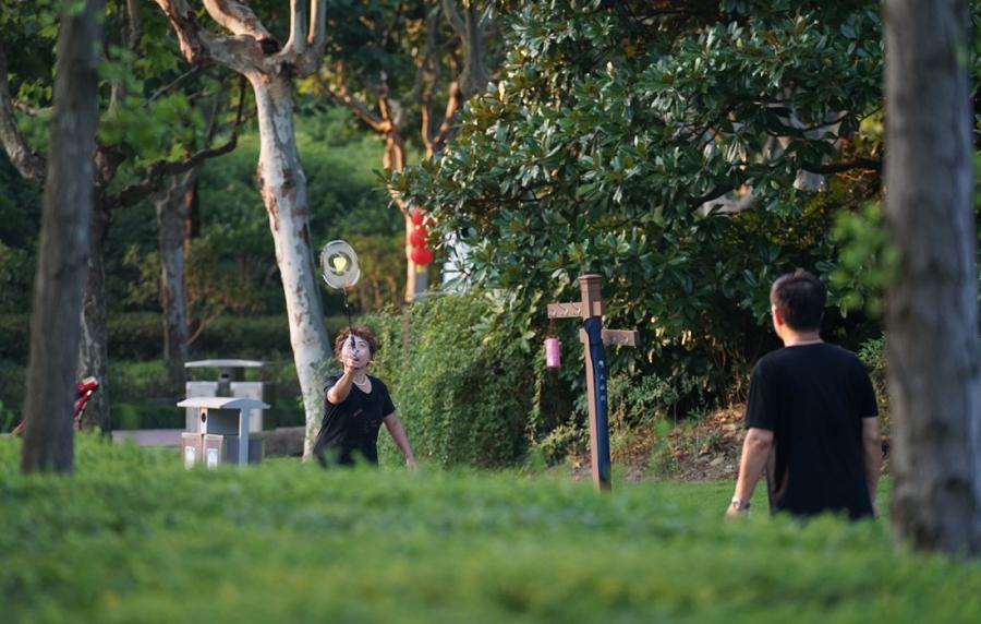 People play badminton in the park.