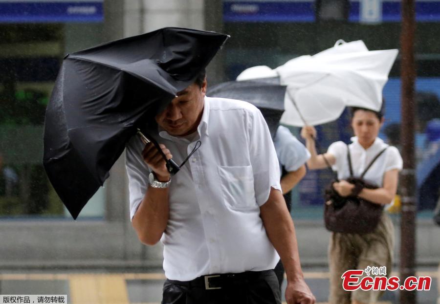 <?php echo strip_tags(addslashes(Passersby using umbrellas struggle against a heavy rain and wind as Typhoon Shanshan approaches Japan's mainland in Tokyo, Japan, Aug. 8, 2018. (Photo/Agencies))) ?>