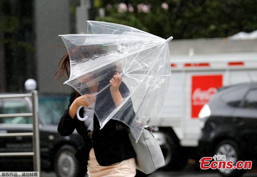 <?php echo strip_tags(addslashes(A woman using an umbrella struggles against a heavy rain and wind as Typhoon Shanshan approaches Japan's mainland in Tokyo, Japan, Aug. 8, 2018. (Photo/Agencies))) ?>