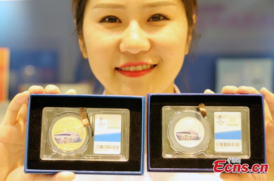 One of the nine sets of souvenirs released by the Beijing Organizing Committee for the 2022 Olympic and Paralympic Winter Games to mark the 10thanniversary of Beijing’s hosting of the 2008 Summer Olympics, Aug. 8, 2018. The souvenirs include badges, a commemorative envelope and stamp albums. (Photo: China News Service/Ren Haixia)