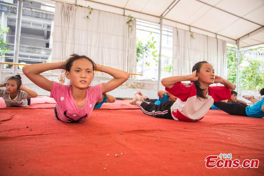 <?php echo strip_tags(addslashes(Twin sisters Wei Liufei (L) and Wei Meifei, 12, train at a gym in Nanning, the capital of South China’s Guangxi Zhuang Autonomous Region, Aug. 9, 2018. Most of the children training with the acrobatics troupe led by Li Dewei are from the poverty-stricken Mashan County and they dream of one day improving the financial position of their families through their performances. (Photo: China News Service/Chen Guanyan))) ?>