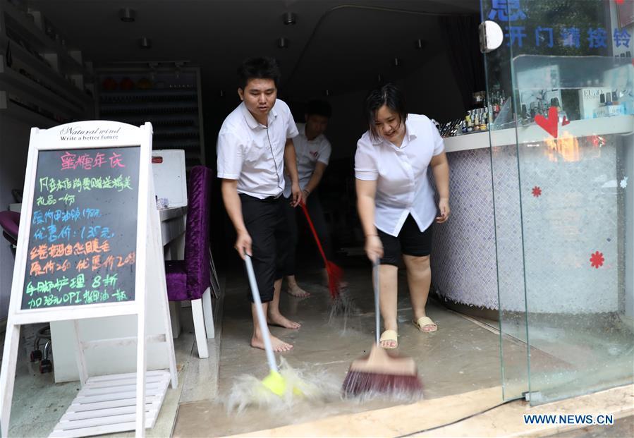 <?php echo strip_tags(addslashes(Staff of a shop drain the floodwater in Haikou, south China's Hainan Province, Aug. 10, 2018. Hainan was hit by heavy rainfalls under the influence of a tropical depression on Friday, which triggered a red alert for rainstorms in seven cities and counties, including Haikou. (Xinhua/Wang Junfeng))) ?>