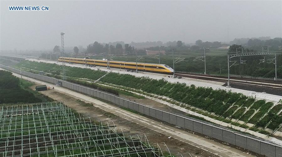 <?php echo strip_tags(addslashes(Aerial photo taken on Aug. 9, 2018 shows a comprehensive inspection train running on the Jinan-Qingdao high-speed railway in Zouping section in Binzhou City, east China's Shandong Province. The Jinan-Qingdao high-speed railway started a joint test recently. With a designed speed of 350 kilometers per hour, the 307.9-kilometer railway is expected to be put into operation at the end of 2018. (Xinhua/Dong Naide))) ?>