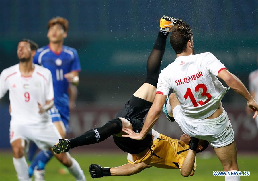 <?php echo strip_tags(addslashes(Pan Wenchieh (Bottom), goalkeeper of Chinese Taipei clashes with Shehab Qumbor of Palestine during the Men's Football Group A match between Chinese Taipei and Palestine at the 18th Asian Games at Patriot Stadium in Bekasi, Indonesia, Aug. 10, 2018. The match ended with a 0-0 draw. (Xinhua/Wang Lili))) ?>