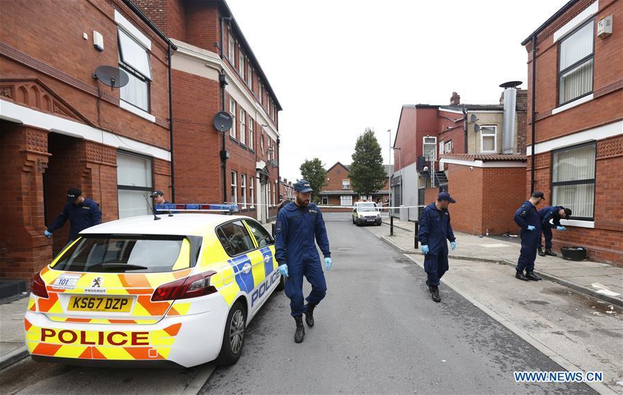 Policemen search the scene of the mass shooting occurring in the Moss Side area, Manchester, Britain, Aug. 12, 2018. A mass shooting in the British city of Manchester wounded 10 people Sunday morning, local authorities said. (Xinhua/Ed Sykes)