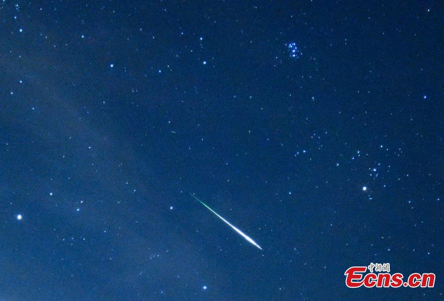 A meteor streaks past stars in the night sky during the Perseid meteor shower in Hong Kong, August 13, 2018. (Photo: China News Service/ Sheung Man Mak)