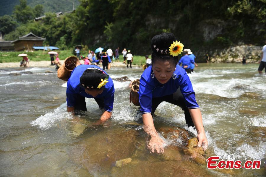 <?php echo strip_tags(addslashes(People from the Miao ethnic group catch fish barehanded or with tools during a folk festival at a river in Taijiang County, Southwest China's Guizhou Province, Aug. 12, 2018. The fishing festival, held on July 2 of the lunar calendar, which falls on Aug. 12 this year, is a chance for recreation and bonding among locals. (Photo: China News Service/Liu Kaifu))) ?>