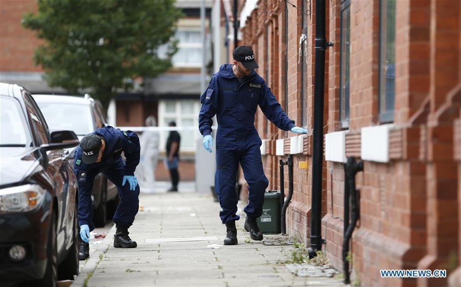 Policemen search the scene of the mass shooting occurring in the Moss Side area, Manchester, Britain, Aug. 12, 2018. A mass shooting in the British city of Manchester wounded 10 people Sunday morning, local authorities said. (Xinhua/Ed Sykes)
