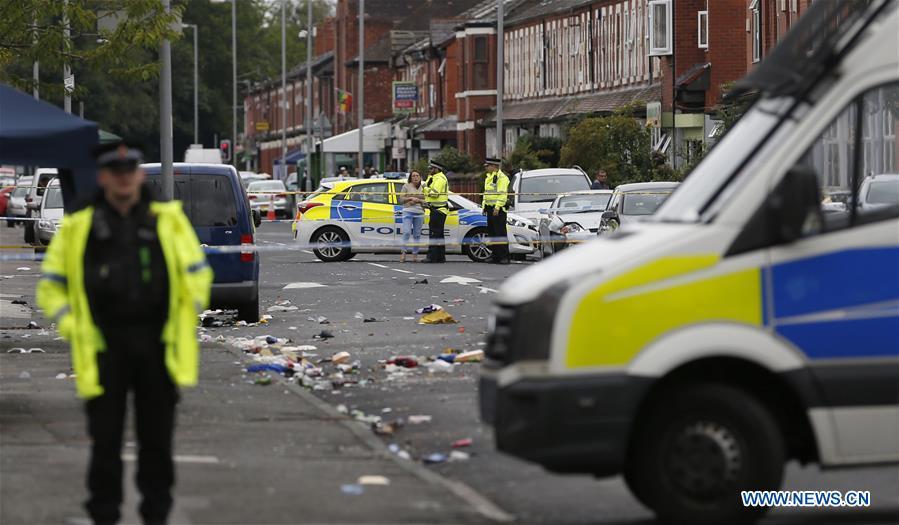 Policemen arrive at the scene of the mass shooting occurring in the Moss Side area, Manchester, Britain, Aug. 12, 2018. A mass shooting in the British city of Manchester wounded 10 people Sunday morning, local authorities said. (Xinhua/Ed Sykes)