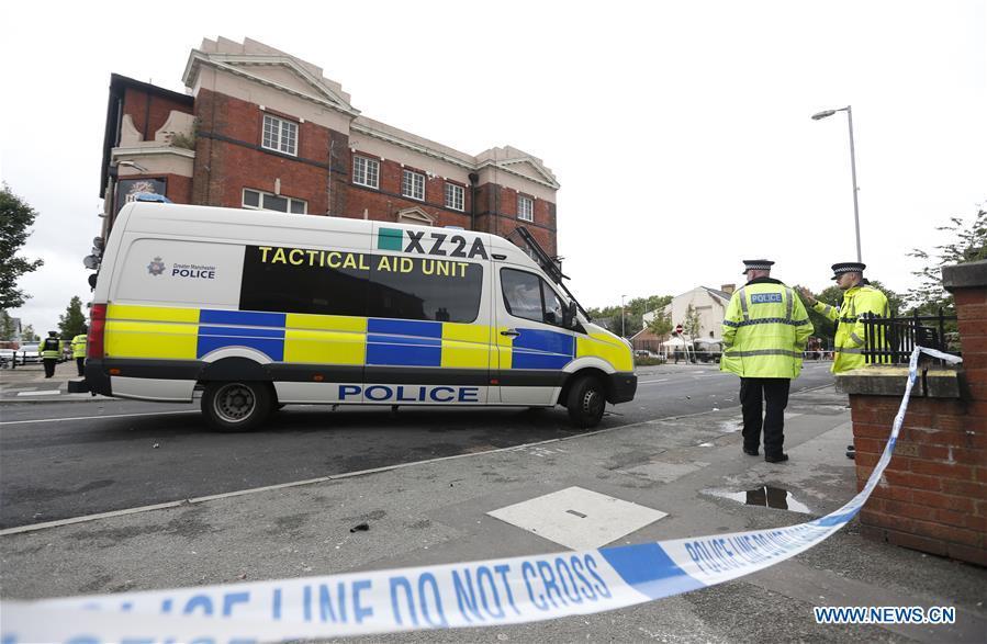 Policemen form a cordon at the scene of the mass shooting occurring in the Moss Side area, Manchester, Britain, Aug. 12, 2018. A mass shooting in the British city of Manchester wounded 10 people Sunday morning, local authorities said. (Xinhua/Ed Sykes)