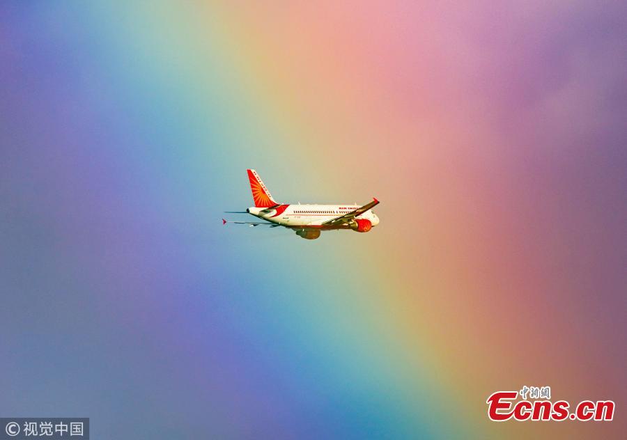 <?php echo strip_tags(addslashes(This stunning image shows a passenger plane flying straight into a rainbow. The jumbo jet breaks through the cloud and into the arc, which produces a kaleidoscope of colour. The moment was captured by photographer Tanay Das, shortly after the Indian Airlines flight took off from Netaji Subhas Chandra Bose International Airport in Kolkata, India. (Photo/VCG))) ?>